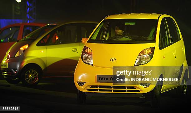 Tata Nano cars are unveiled during the vehicle's launch in Mumbai on March 23, 2009. Tata Motors took the wraps off the world's cheapest car,...