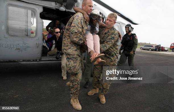 Military personel carry Joan Xavier after been rescued from Point Mitchell, Dominica on September 27,2017. Ms Xavier lost everything and plans to...