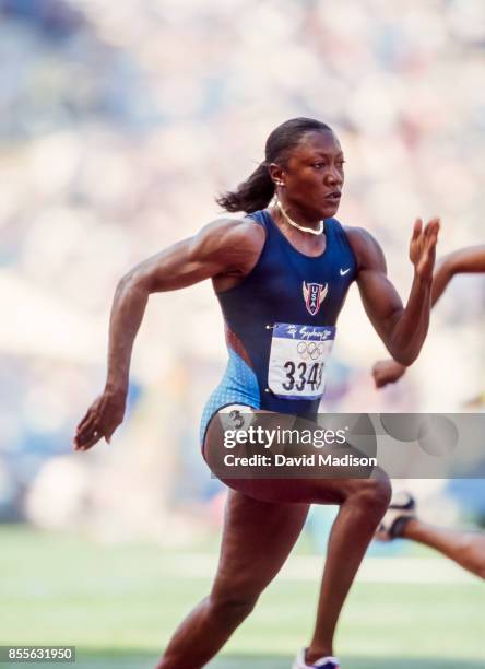 Chryste Gaines of the USA runs in a first round heat of the Women's 100 meter race of the 2000 Summer Olympics track and field competition on...