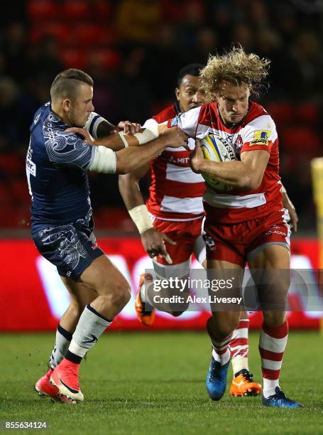 Billy Twelvetrees of Gloucester Rugby is tackled by Mark Jennings of Sale Sharks during the Aviva Premiership match between Sale Sharks and...