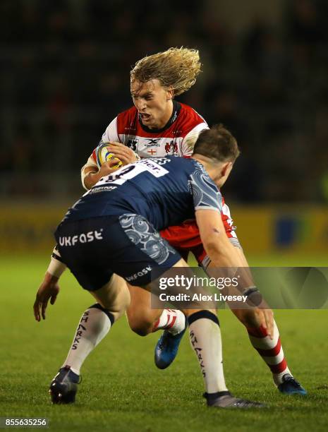 Billy Twelvetrees of Gloucester Rugby runs at Sam James of Sale Sharks during the Aviva Premiership match between Sale Sharks and Gloucester Rugby at...