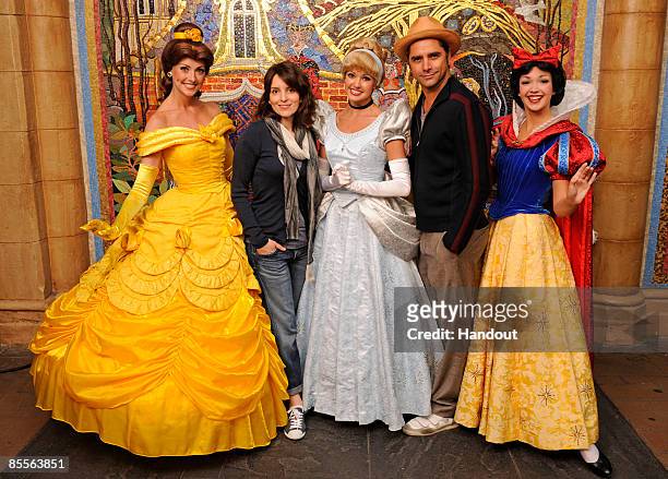 In this handout photo from Walt Disney World, actors dressed as princesses Belle , Cinderella and Snow White pose with "30 Rock" actress and...