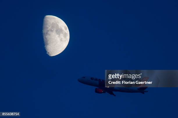 Startin plane of the airline 'easyjet' is pictured in front of the rising moon on September 29, 2017 in Berlin, Germany.