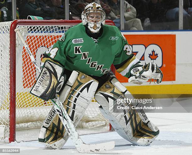Trevor Cann of the London Knights keeps an eye on the play in game one of the opening round of the 2009 play-offs against the Erie Otters on March...