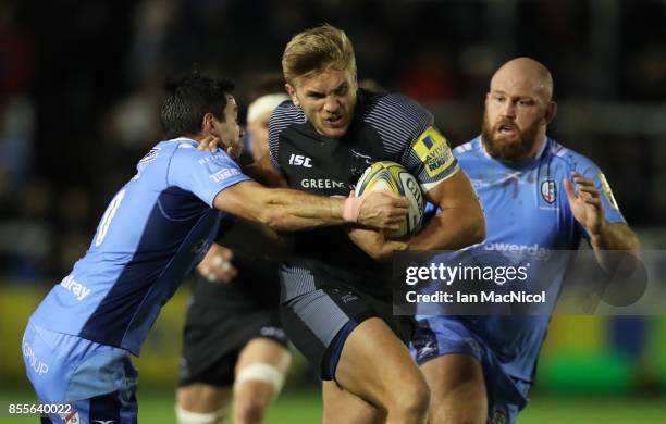 Chris Harris of Newcastle Falcons is tackled by James Marshall of London Irish during the Aviva Premiership match between Newcastle Falcons and...