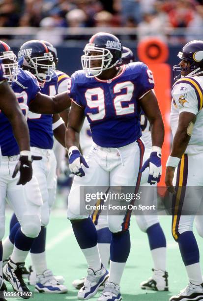 Michael Strahan of the New York Giants looks on against the Minnesota Vikings during an NFL football game September 29, 1996 at Giants Stadium in...