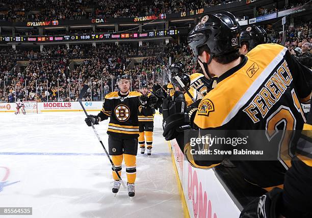 Chuck Kobasew of the Boston Bruins celebrates goal with teammates against the New Jersey Devils at the TD Banknorth Garden on March 22, 2009 in...