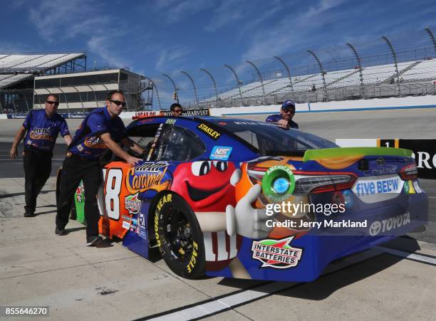 Crew members push the M&M's Caramel Toyota, driven by Kyle Busch ·, down pit road prior to qualifying for the Monster Energy NASCAR Cup Series Apache...