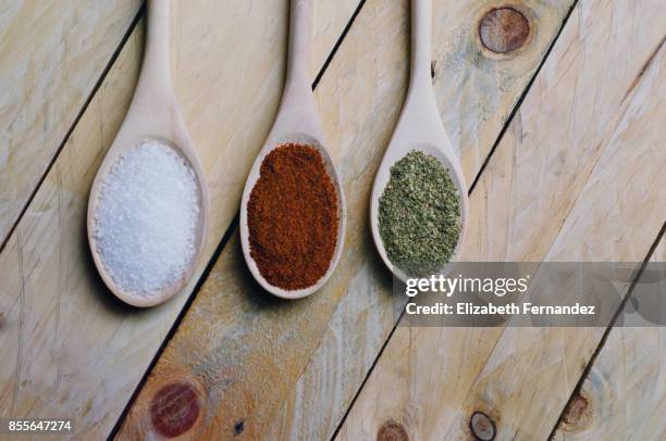 spices on spoons in wooden background - 食品添加物 ストックフォトと画像