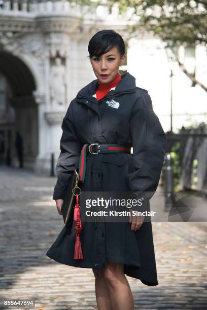 Buying manager women's design wear Selfridges Jeannie Lee wears a Gucci belt, Northface jacket, Balenciaga bag on day 2 of London Womens Fashion Week...