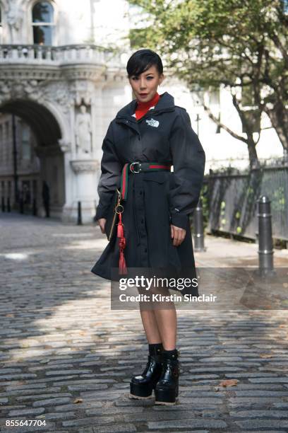 Buying manager women's design wear Selfridges Jeannie Lee wears a Gucci belt, Northface jacket, Sacai shoes, Balenciaga bag on day 2 of London Womens...