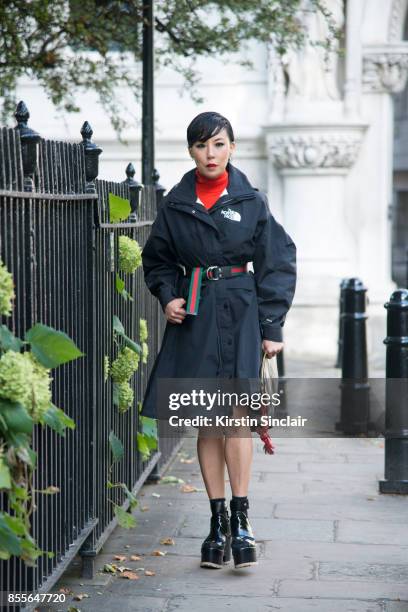 Buying manager women's design wear Selfridges Jeannie Lee wears a Gucci belt, Northface jacket, Sacai shoes, Balenciaga bag on day 2 of London Womens...