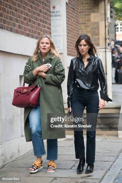 Fashion Pr Liz Mathews wears a Mother of Pearl jacket and a Hill and Friends bag with British writer, host, model, and fashion designer Alexa Chung...