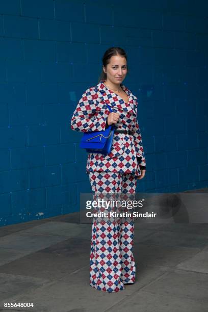Editorial director at Who What Wear UK Hannah Almassi wears a vintage suit and a Sophie Hulme bag on day 2 of London Womens Fashion Week...