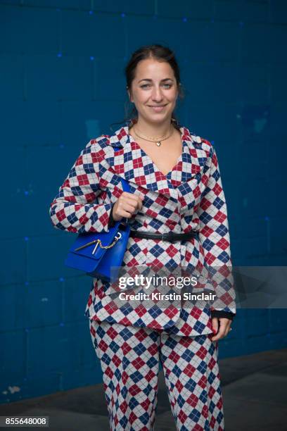 Editorial director at Who What Wear UK Hannah Almassi wears a vintage suit and a Sophie Hulme bag on day 2 of London Womens Fashion Week...