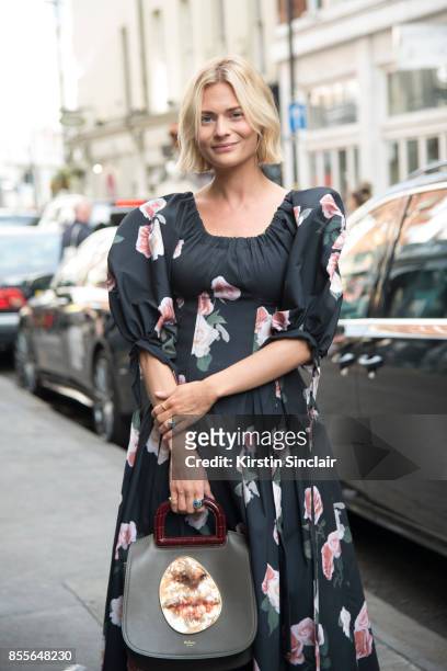Fashion blogger Pandora Sykes wears a Rejina Pyo dress, Mulberry bag and vintage boots on day 2 of London Womens Fashion Week Spring/Summer 2018, on...
