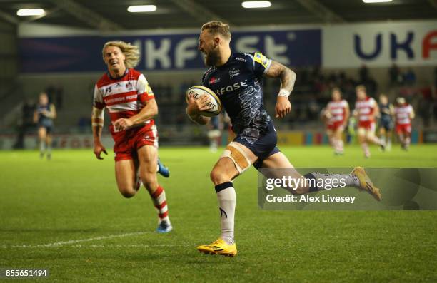 Byron McGuigan of Sale Sharks breaks away to score his third try during the Aviva Premiership match between Sale Sharks and Gloucester Rugby at AJ...