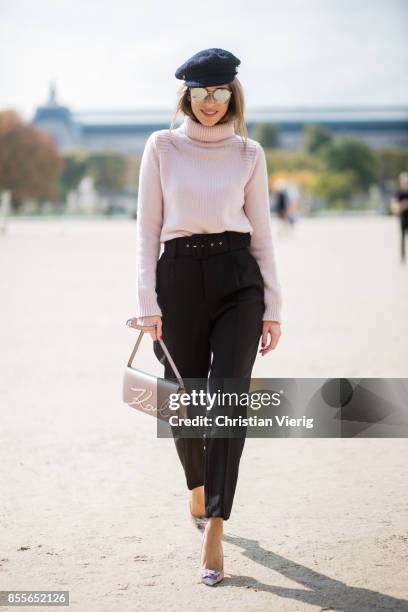 Alexandra Lapp wearing high waist pants in black from Zara, cashmere turtleneck in light pink from Jil Sander, light pink calf leather logo plaque...