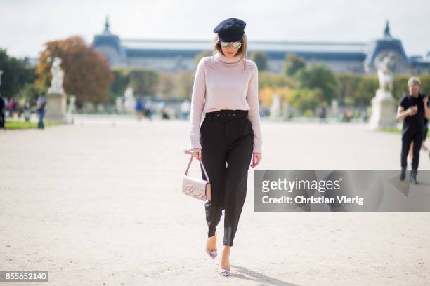 Alexandra Lapp wearing high waist pants in black from Zara, cashmere turtleneck in light pink from Jil Sander, light pink calf leather logo plaque...