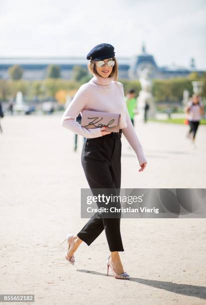 Alexandra Lapp wearing high waist pants in black from Zara, cashmere turtleneck in light pink from Jil Sander, light pink calf leather logo plaque...