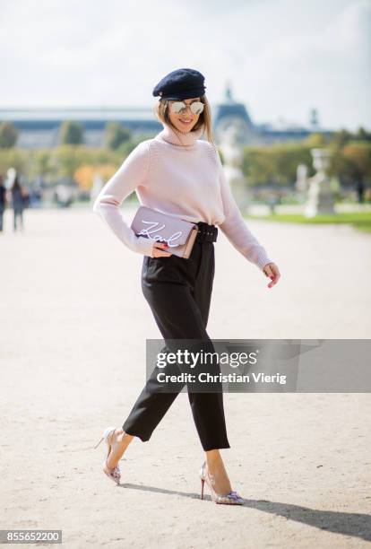 Alexandra Lapp wearing high waist pants in black from Zara, cashmere turtleneck in light pink from Jil Sander, light pink calf leather logo plaque...