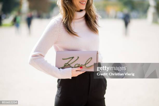 Alexandra Lapp wearing high waist pants in black from Zara, cashmere turtleneck in light pink from Jil Sander, light pink calf leather logo plaque...