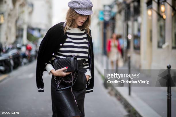 Alexandra Lapp wearing an A-line leather rocky biker skirt from SET Fashion, striped knit jumper from Zara, plaid Zara hat, Isabel Marant slouchy...
