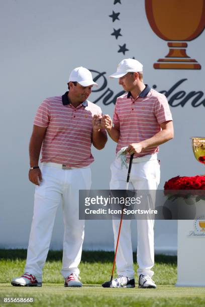 Golfer Patrick Reed and Jordan Spieth give each other a fist bump before teeing off on the first hole during the second round of the Presidents Cup...