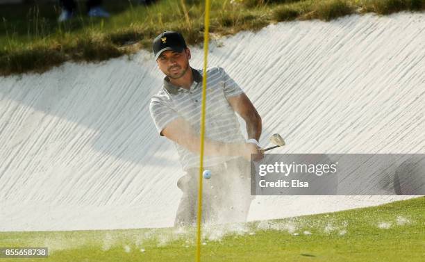 Jason Day of Australia and the International Team plays a shot from a bunker on the 14th hole during Friday four-ball matches of the Presidents Cup...