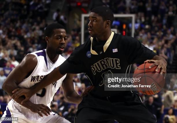 Twaun Moore of the Purdue Boilermakers moves the ball against Justin Dentmon of the Washington Huskies during the second round of the NCAA Division I...