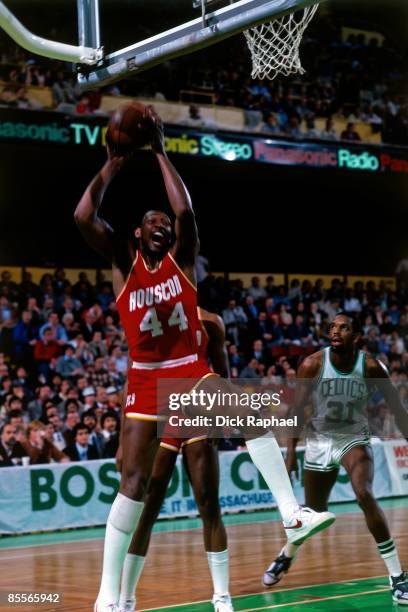 Elvin Hayes, of the Houston Rockets grabs a rebound against Cedric Maxwell of the Boston Celtics during a game played in 1981 at the Boston Garden in...