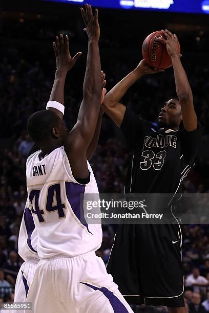 Twaun Moore of the Purdue Boilermakers shoots over Darnell Gant of the Washington Huskies during the second round of the NCAA Division I Men's...