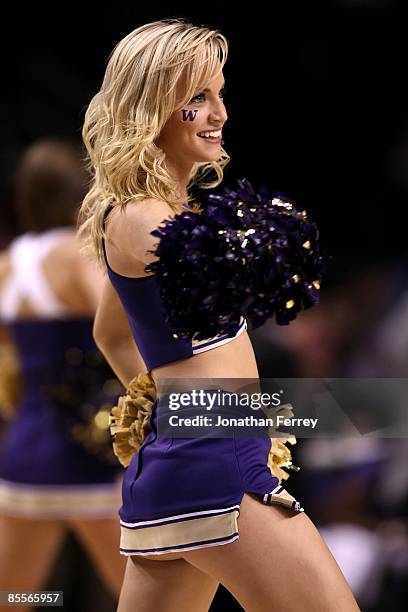 Washington Huskies cheerleader performs during a break in the action against the Purdue Boilermakers during the second round of the NCAA Division I...