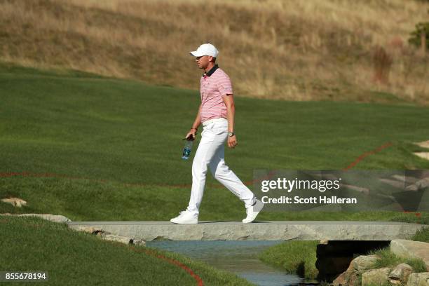 Daniel Berger of the U.S. Team crosses a bridge on the 15th hole during the second round of the Presidents Cup at Liberty National Golf Club on...