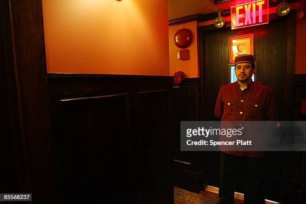 Jose, a bell-hop, waits in the hallway of the Jane Hotel, a new hotel built around the concept of budget conscious travel with style on March 23,...