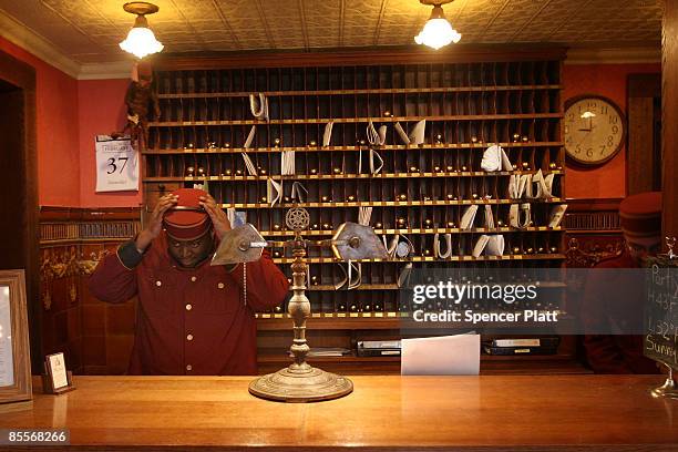 Jerry Desmaratts adjusts his hat while working at the front desk of the Jane Hotel, a new hotel built around the concept of budget conscious travel...