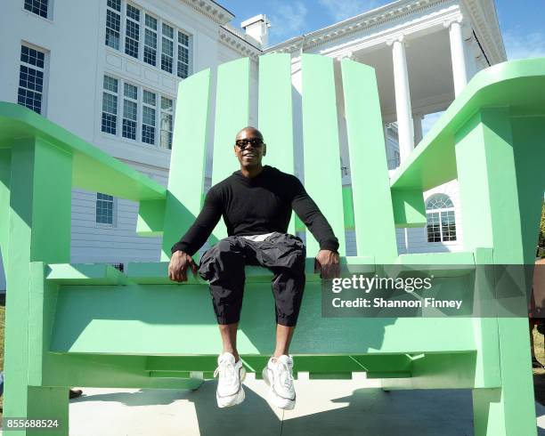Dave Chappelle sits in the big green chair, a landmark on the campus of the Duke Ellington School of the Arts on September 29, 2017 in Washington, DC.