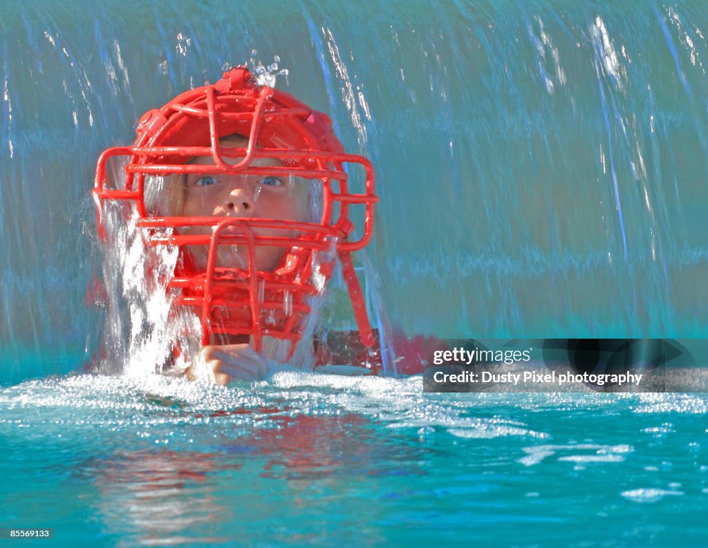 Boy in swimming pool with baseball mask