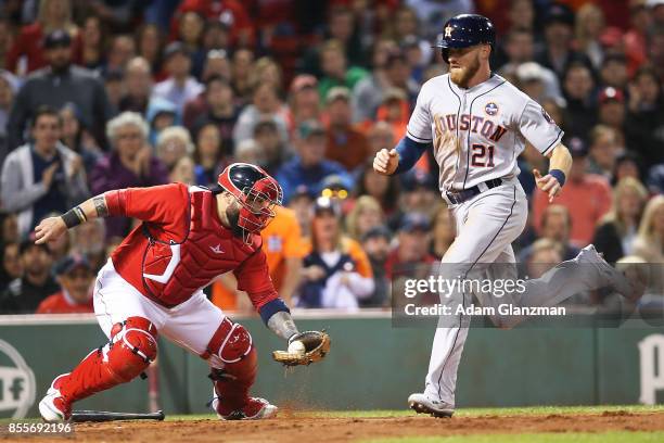 Derek Fisher of the Houston Astros scores past the tag of Sandy Leon of the Boston Red Sox in the third inning of a game at Fenway Park on September...