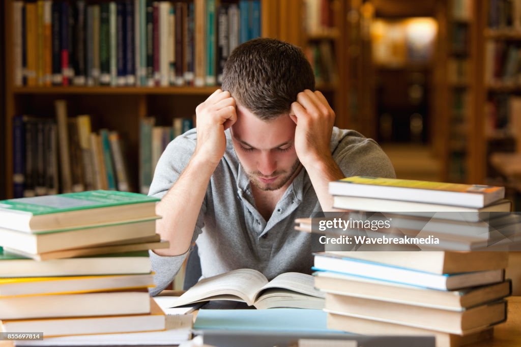 Tired student having a lot to read