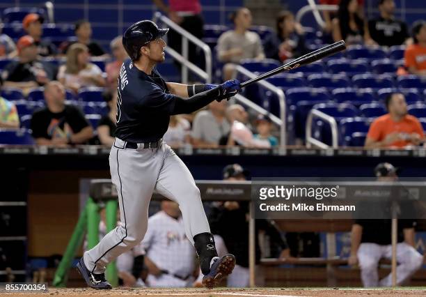 Lane Adams of the Atlanta Braves hits a three run home run in the first inning during a game against the Miami Marlins at Marlins Park on September...
