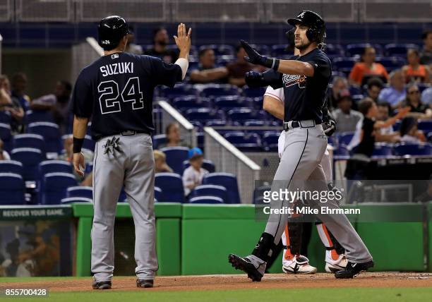 Lane Adams of the Atlanta Braves is congratulated by Kurt Suzuki after hitting a three run home run in the first inning during a game against the...