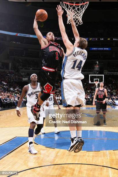 Derrick Rose of the Chicago Bulls attempts a dunk against Oleksiy Pecheriv of the Washington Wizards at the Verizon Center on March 23, 2009 in...