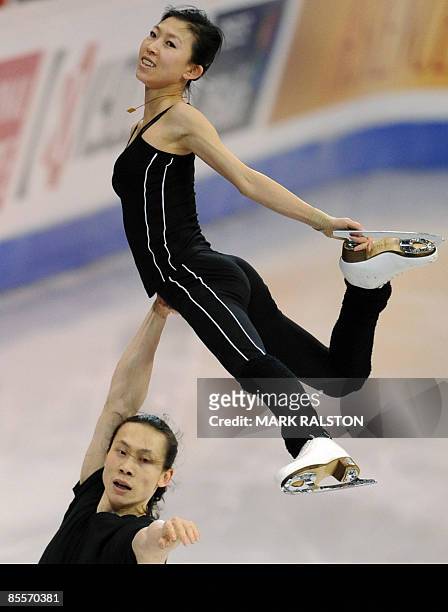 Tong Jian lifts partner Pang Qing of China as they skate during a practice session for the Pairs event ahead of the 2009 World Figure Skating...