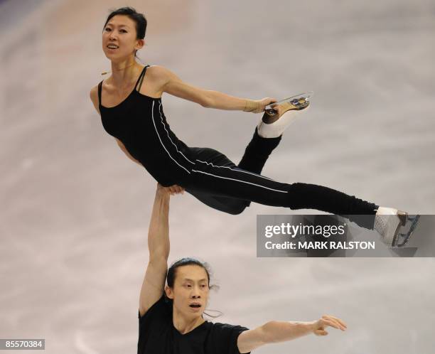 Tong Jian lifts partner Pang Qing of China as they skate during a practice session for the Pairs event ahead of the 2009 World Figure Skating...