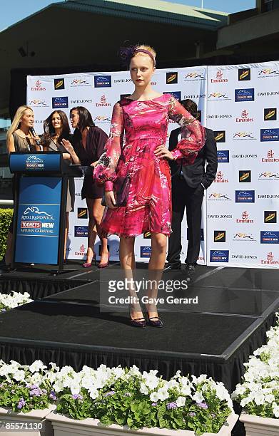 Collette Garnsey, Kate Waterhouse and Megan Gale host Models onstage wearing designs from David Jones during the Tooheys New Autumn Racing Carnival...