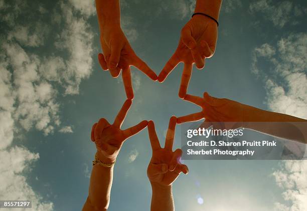 star power children's hands making a star - fünf personen stock-fotos und bilder
