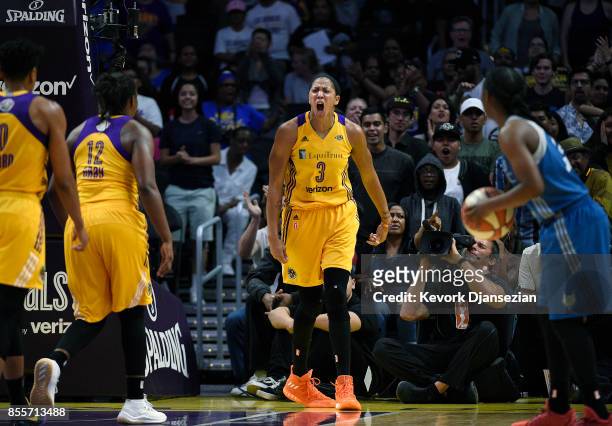 Candace Parker of the Los Angeles Sparks celebrates after blocking a shot against Maya Moore of the Minnesota Lynx during the first half of Game...