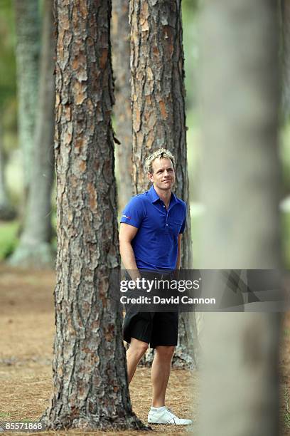 Luke Donald of England in tree trouble at the 3rd hole during the Els For Autism Pro-Am on the Champion Course at the PGA National Golf Club on March...