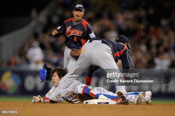 Yong-Kyu Lee of Korea is caught stealing second base by shortstop Hiroyuki Nakajima of Japan in the sixth inning of the finals of the 2009 World...